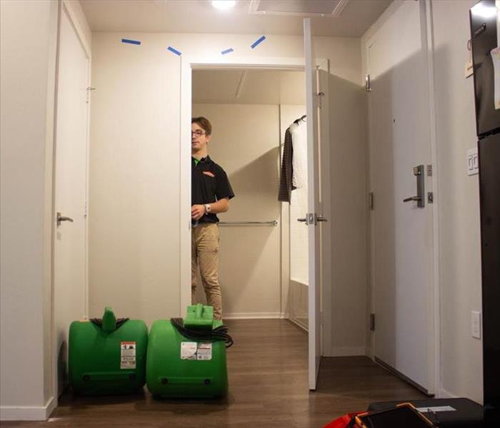 SERVPRO employee setting up air movement devices. 